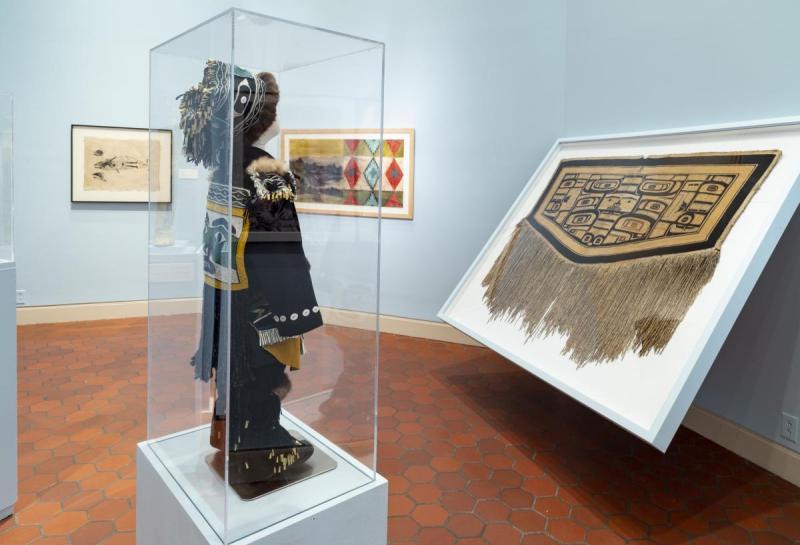 Image Credits: (Top) Artist Lily Hope photographed in front of her Lineage Robe, now in the collection of the Portland Art Museum. Coutresy of the artist. (Bottom) Exhibition view of Lily Hope's Little Watchman at The Fralin Museum of Art. Credit: Leah Stearns, 2018.